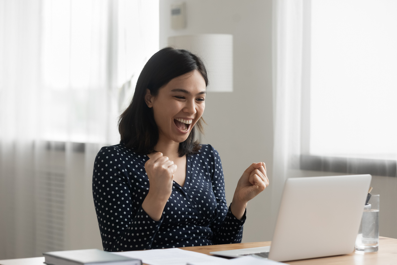 Overjoyed asian lady office worker get reward promotion by email